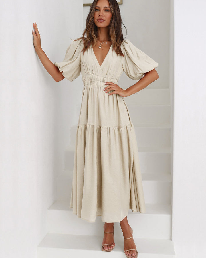 Beautiful women's elegant midi dress with charming puff sleeves, a classic look for any woman.