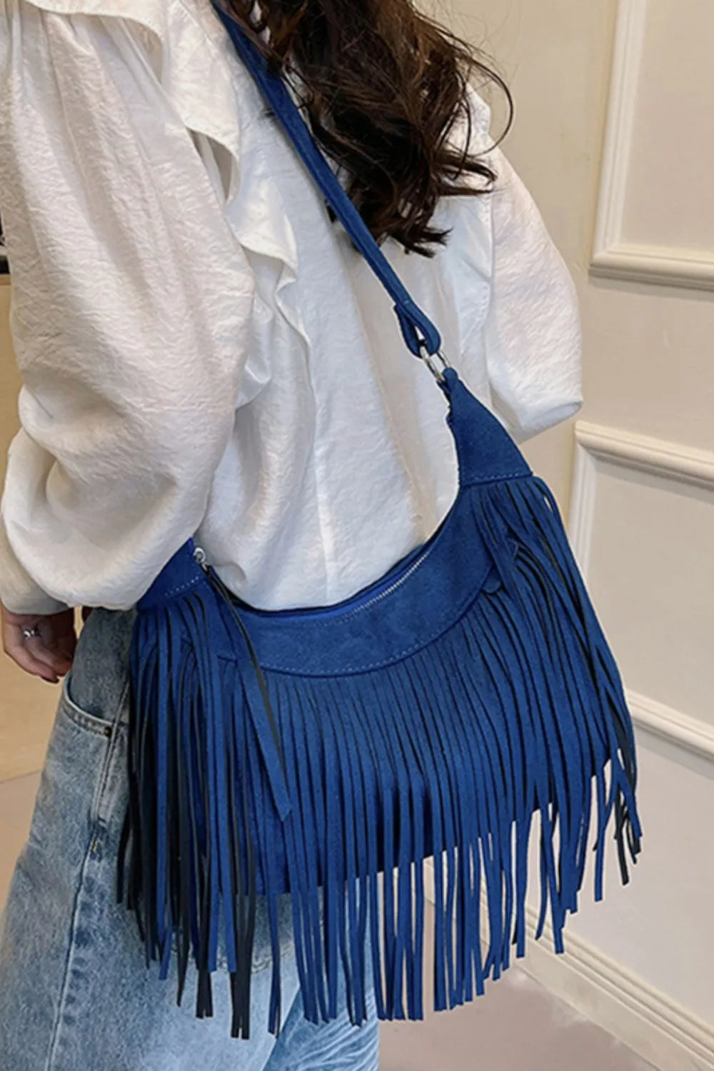 Elegant suede fringe shoulder bag, a versatile women's accessory for achieving boho chic looks.