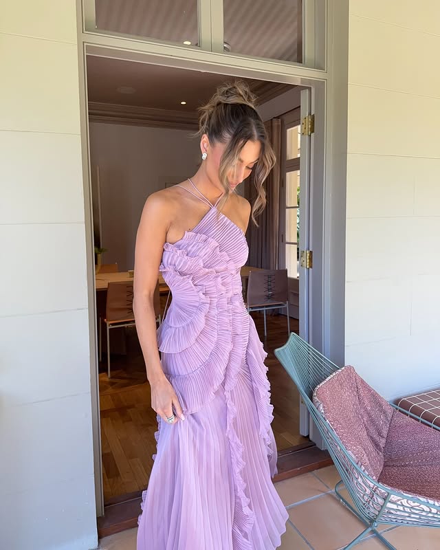 Long elegant women's maxi dress with cascading ruffles, a sophisticated choice for formal evening wear.