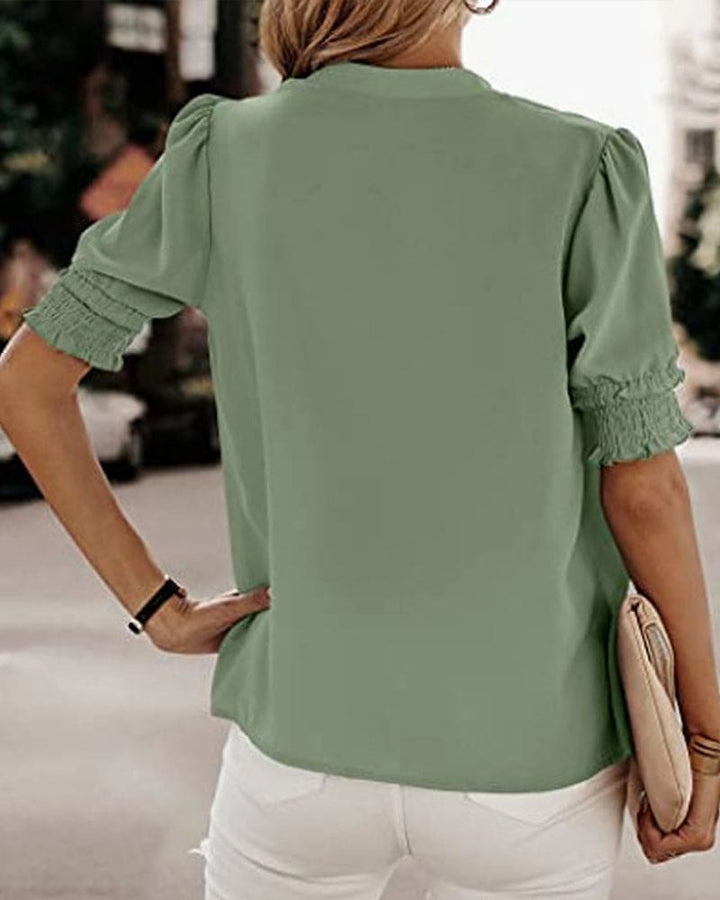 Effortless style with this women's V-neck puff sleeve blouse. Relaxed fit short sleeve top.