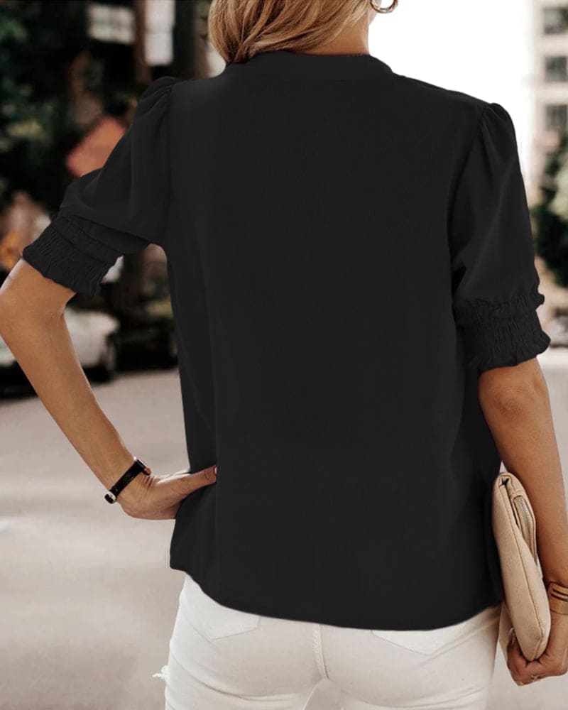 Women's V-neck short sleeve blouse with puff sleeves. Chic, comfortable top for spring office & casual.