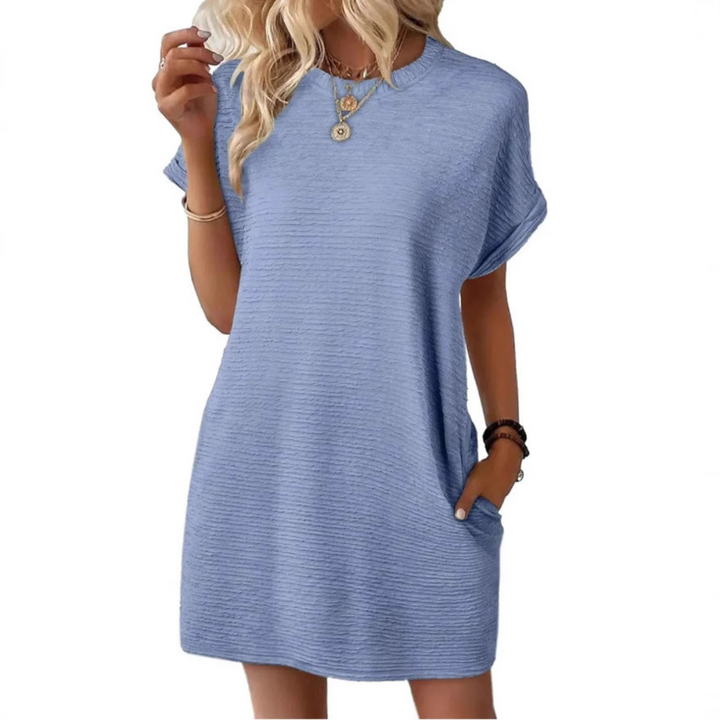 Back view of women's oversized t-shirt mini dress, showcasing the relaxed drape, short sleeves & versatile casual design.