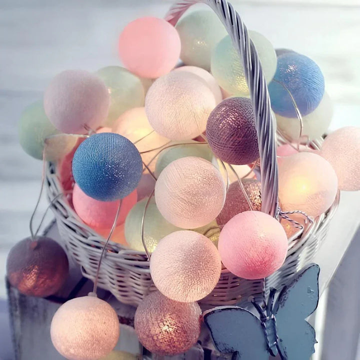 Close-up of the textured cotton balls on the warm LED decorative string lights.