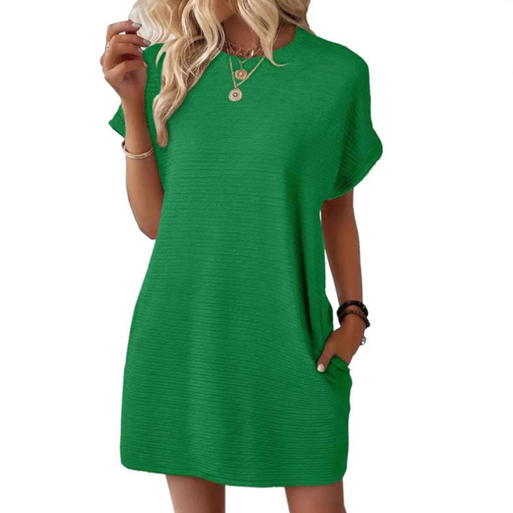 Front view of women's oversized t-shirt mini dress with round neck, short sleeves & pockets. Perfect for casual comfort.