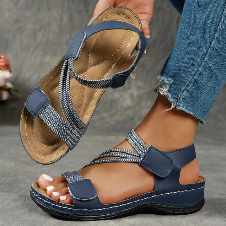 Women's comfort sandals with adjustable straps, cushioned sole for walking.