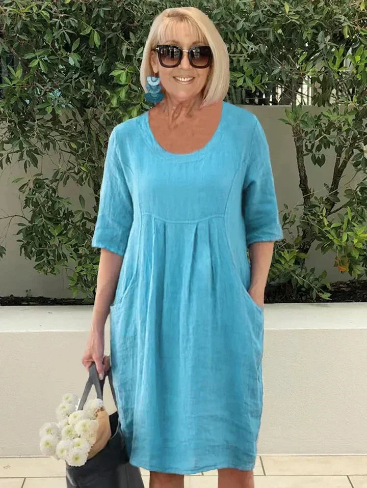 Comfortable women's relaxed fit midi dress with practical pockets, ideal for a versatile, loose summer style.