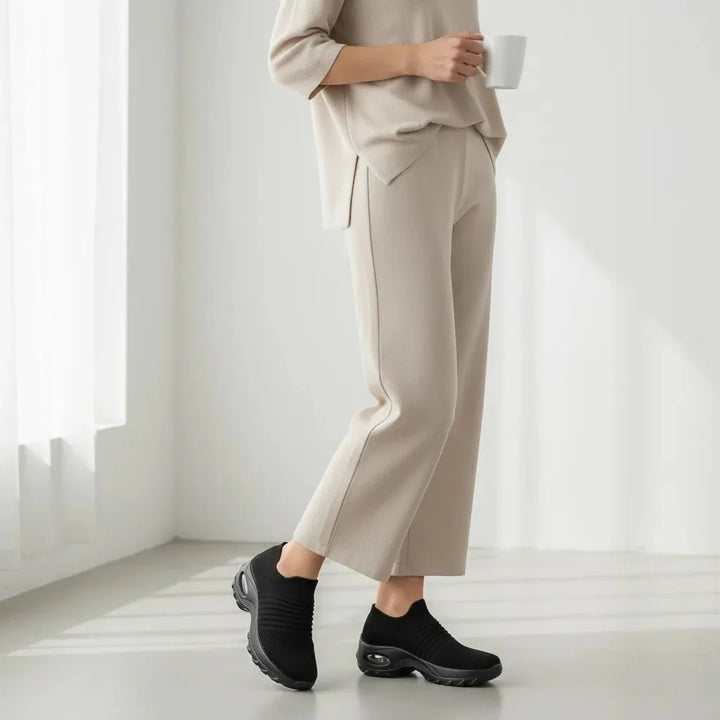 Versatile Black women's sneakers: slip-on, arch support, air cushion sole for ultimate comfort.