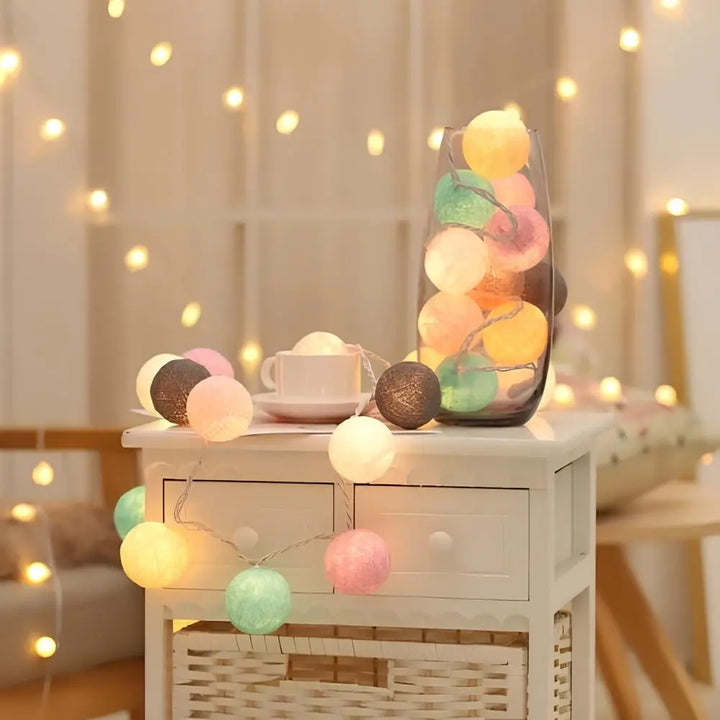 Cotton ball string lights illuminating a reading nook, providing warm and inviting ambiance.