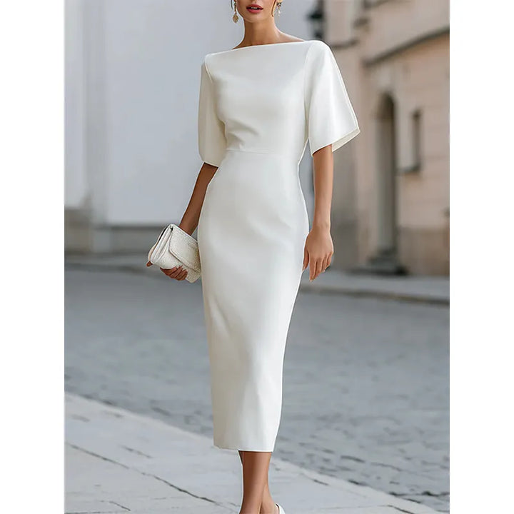 Sophisticated black short sleeve bodycon midi dress with boat neck, ideal for evening wear or versatile chic style.