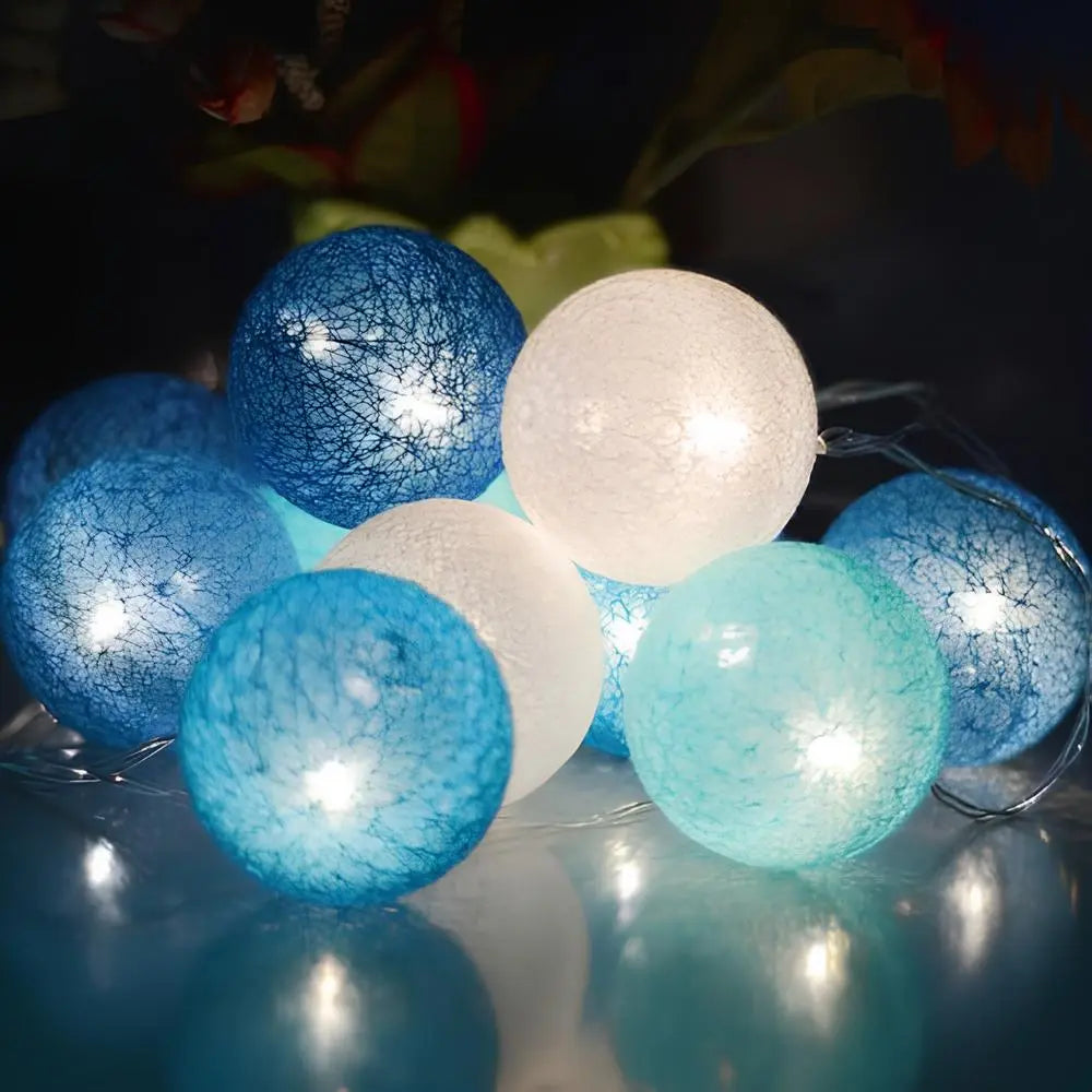 Warm LED cotton ball string lights coiled neatly, ready to be unravelled for decor.