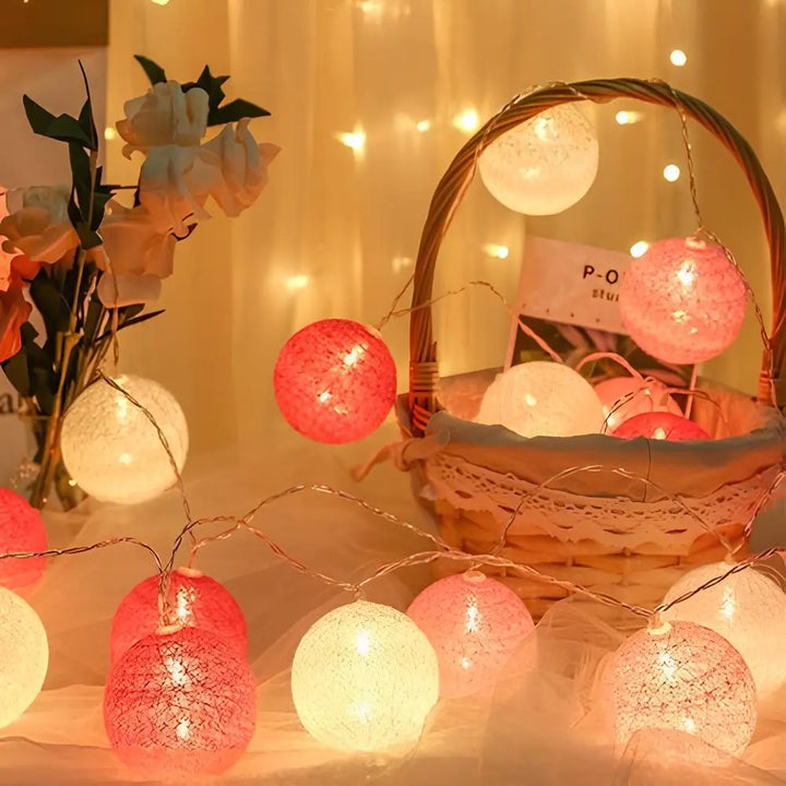 Long strand of decorative cotton ball LED lights, perfect for party or home decor.