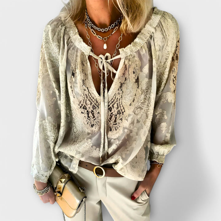 Casual autumn fashion V-neck blouse for women, intricate lace overlay and charming tie front accent.