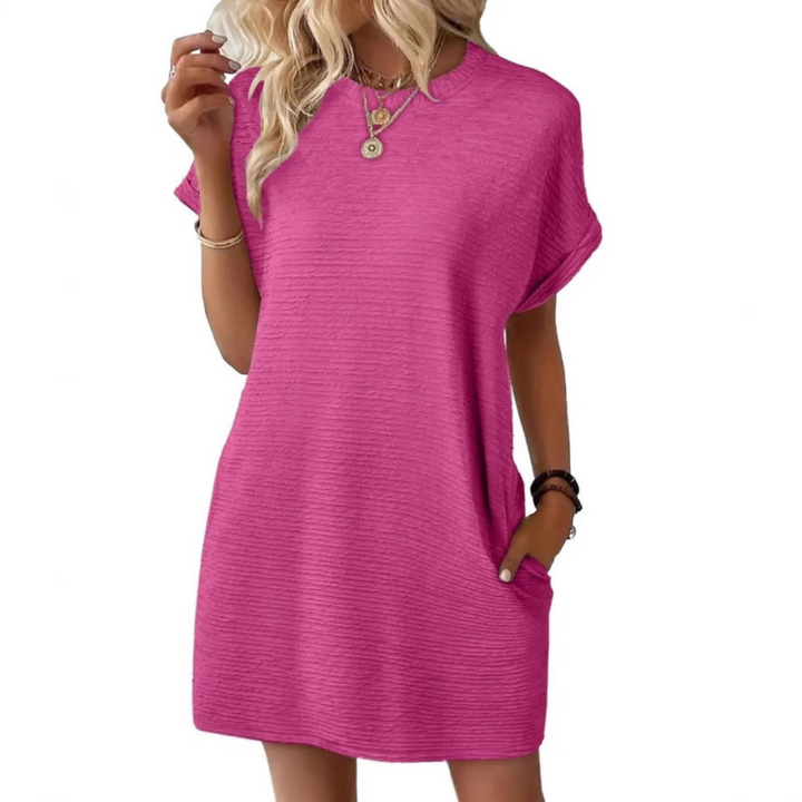 Women's oversized t-shirt mini dress, black, relaxed fit, short sleeves & practical side pockets. Perfect casual summer wear.