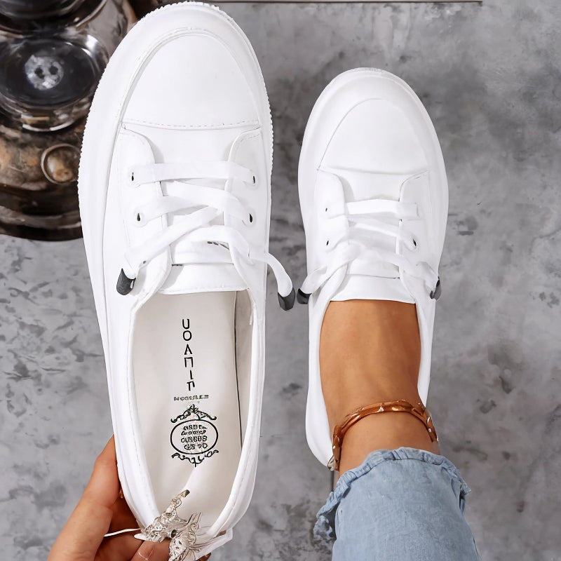 Beige women's casual lace-up flat sneakers, featuring a low profile design for everyday style & comfort.