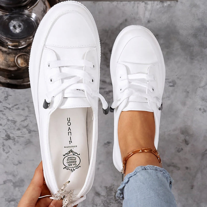 Beige women's casual lace-up flat sneakers, featuring a low profile design for everyday style & comfort.