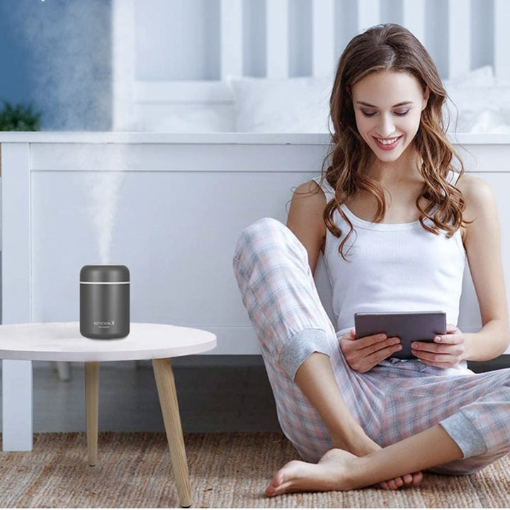 Sleek portable humidifier, improves air quality for office comfort & respiratory health.