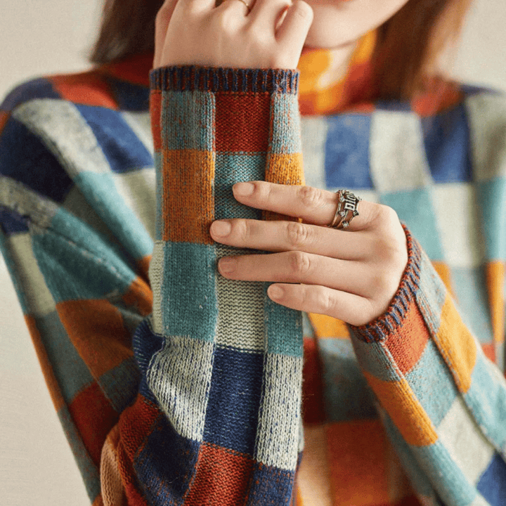 Warm knit women's turtleneck pullover, featuring a stylish patchwork design and long sleeves.