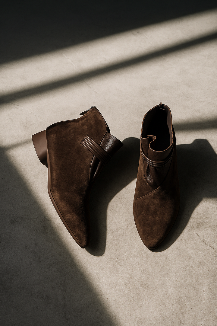 Women's chic brown low heel ankle booties, offering everyday comfort and versatile fall fashion.