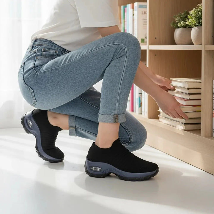 Comfortable Black women's slip-on sneakers with arch support & air cushion for long walks.