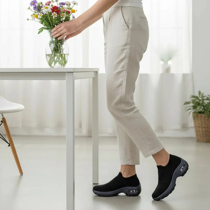 Stylish Black women's slip-on casual sneakers, offering arch support for versatile wear.