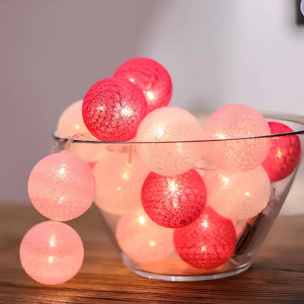 Decorative cotton ball garland providing gentle, warm LED lighting for a child's room.