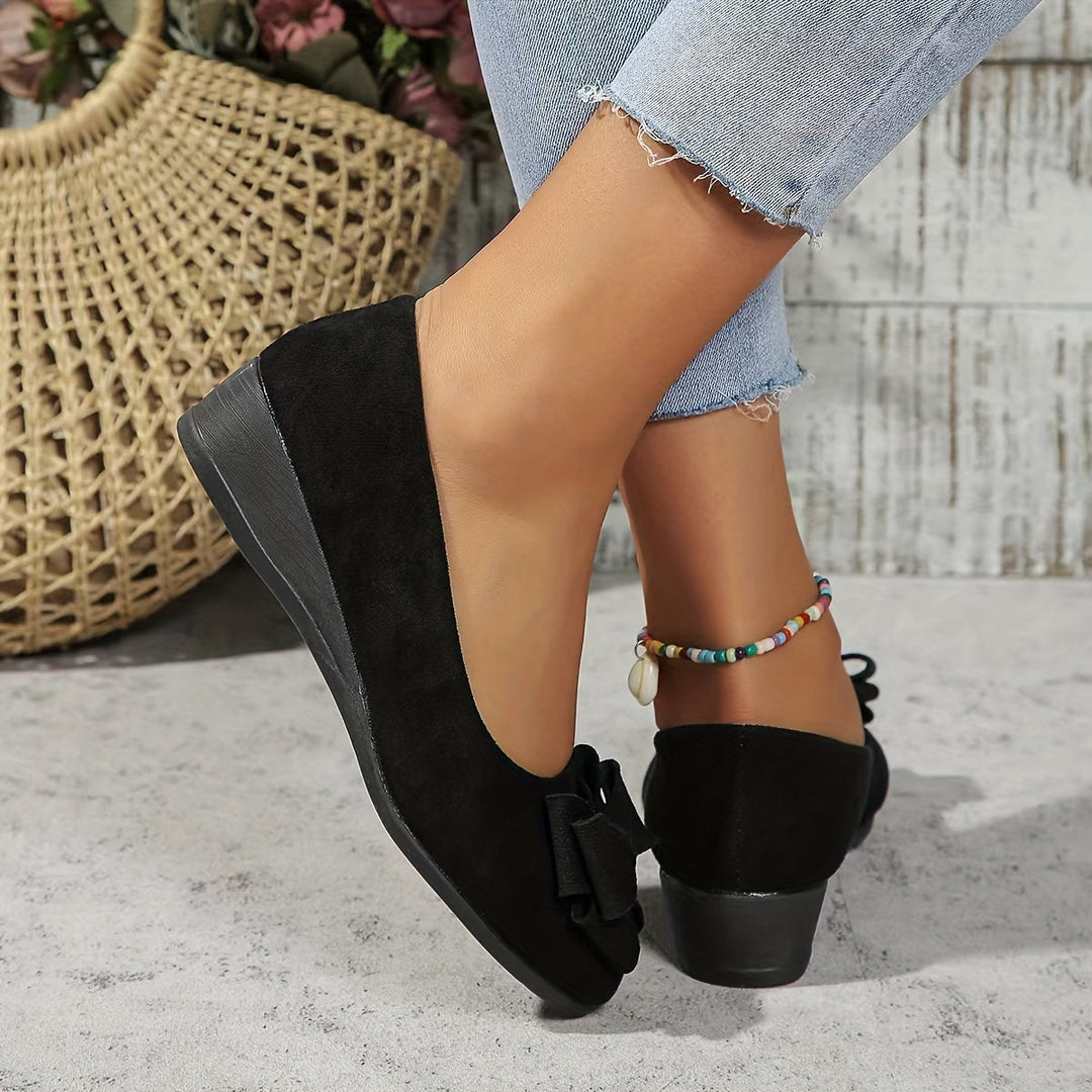 Pink suede wedge ballet flats for women, elegant slip-on shoes with a pretty bow detail.