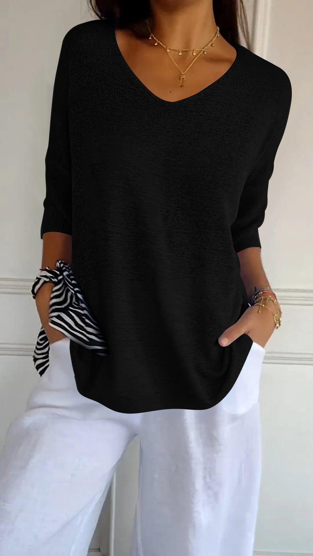 Versatile women's V-neck knit top. Long sleeve design for elegant casual wear & comfort.