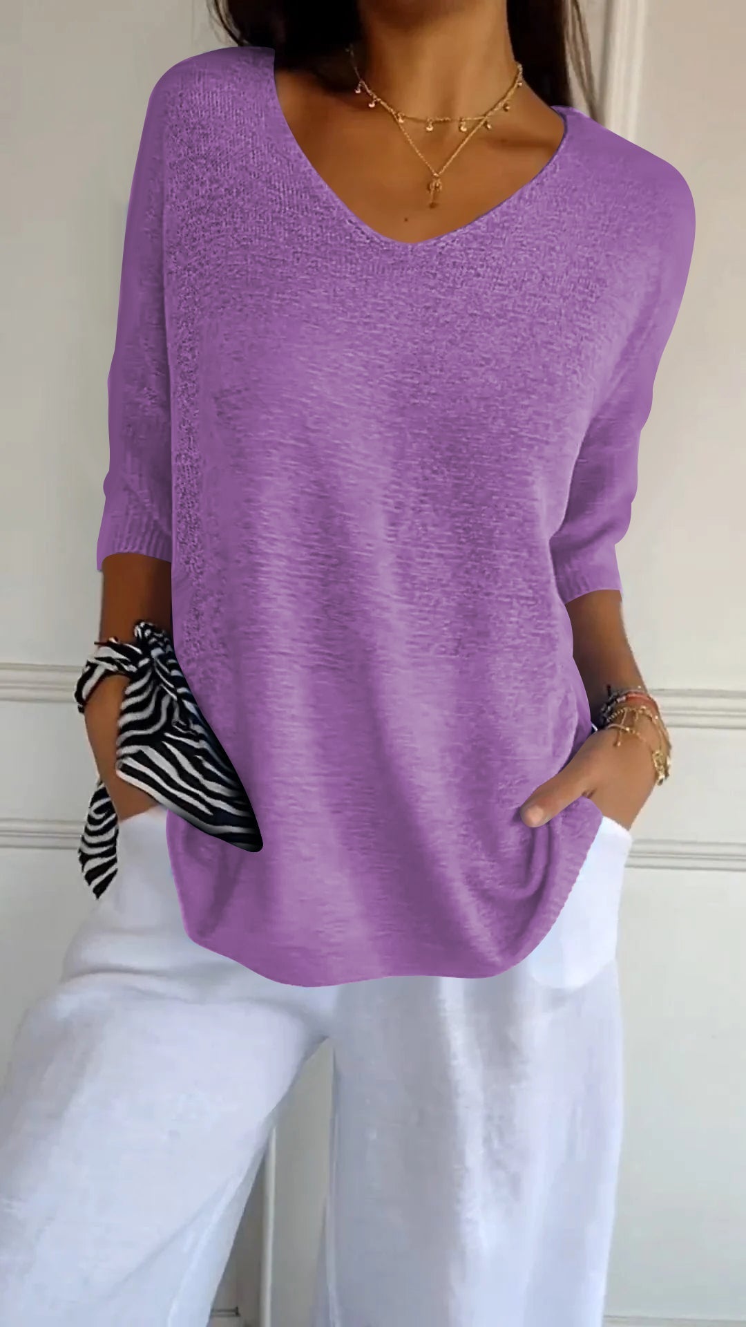Relaxed fit V-neck knit top for women. Chic, comfortable, and perfect for casual everyday style.