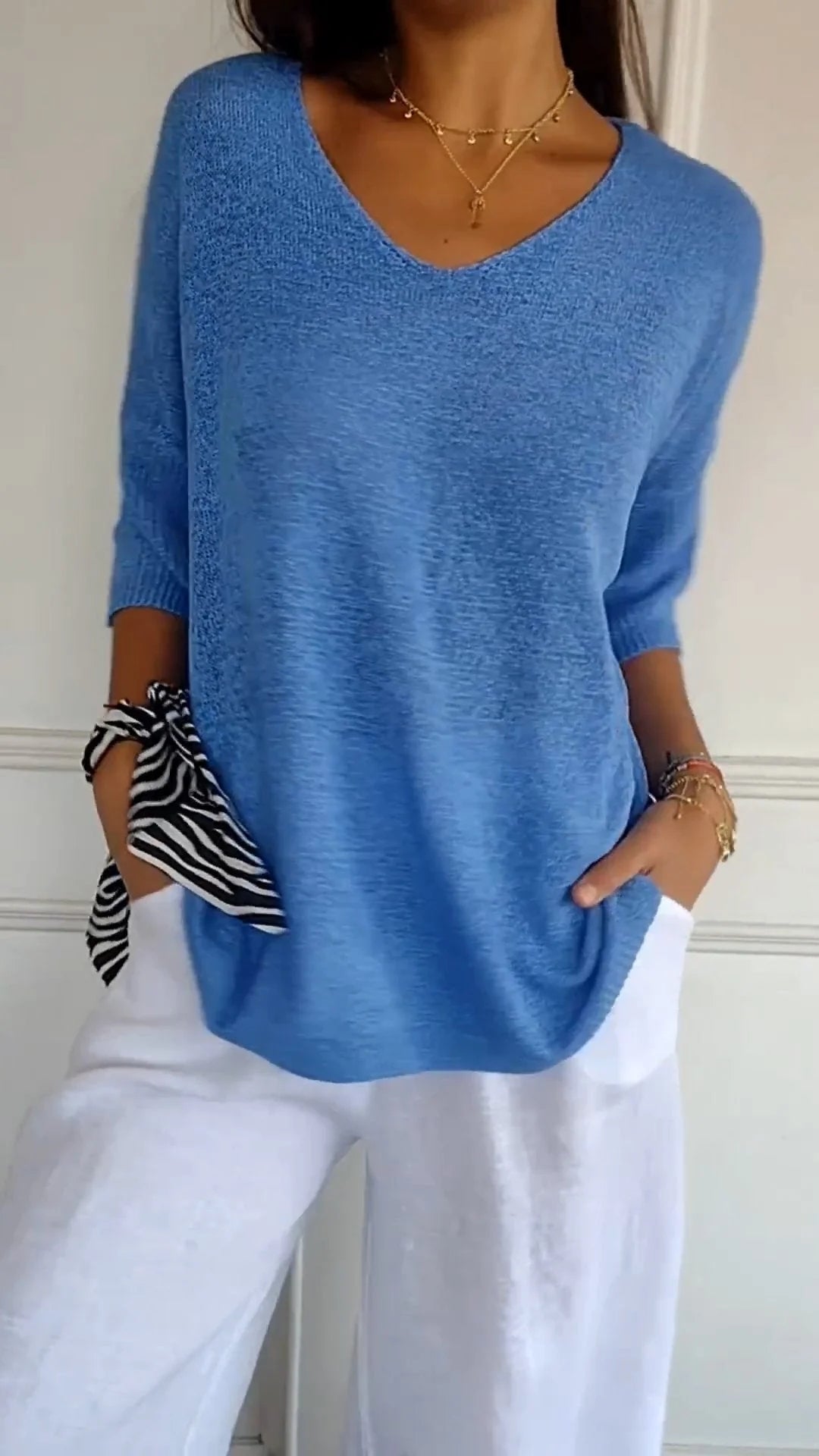 Elegant women's V-neck knit top, versatile for casual wear. Comfortable long sleeve design.