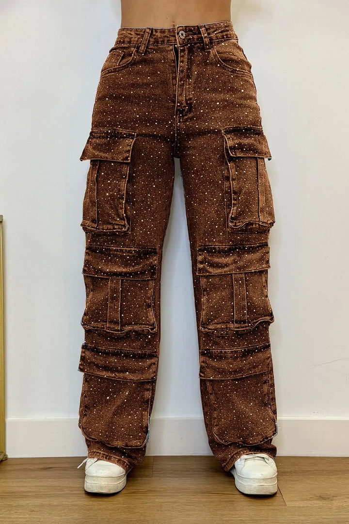 Close-up of sparkling rhinestone embellishments on trendy women's cargo jeans. Fashionable detail.