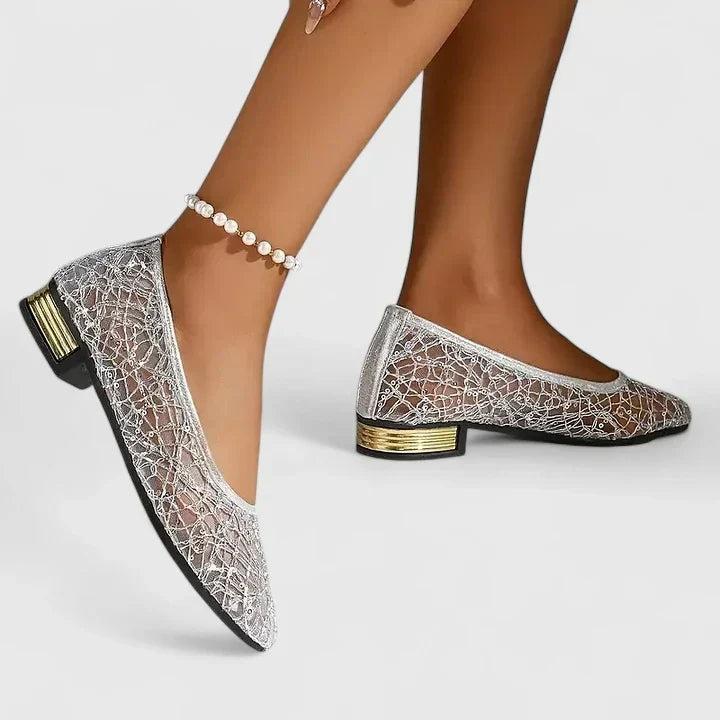 Luxurious silver pointed-toe flats for women, adorned with a dazzling gold heel, ideal for evening events & special occasions.