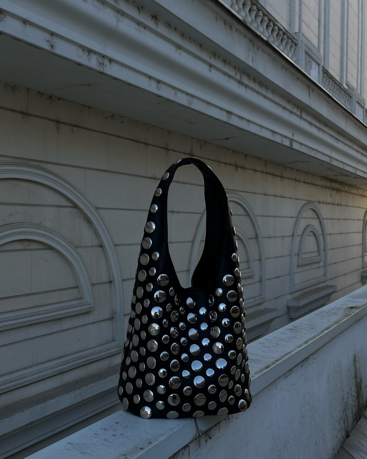 Stylish black women's studded rivet shoulder bag, perfect for evening events. Fashion accessory with statement design.