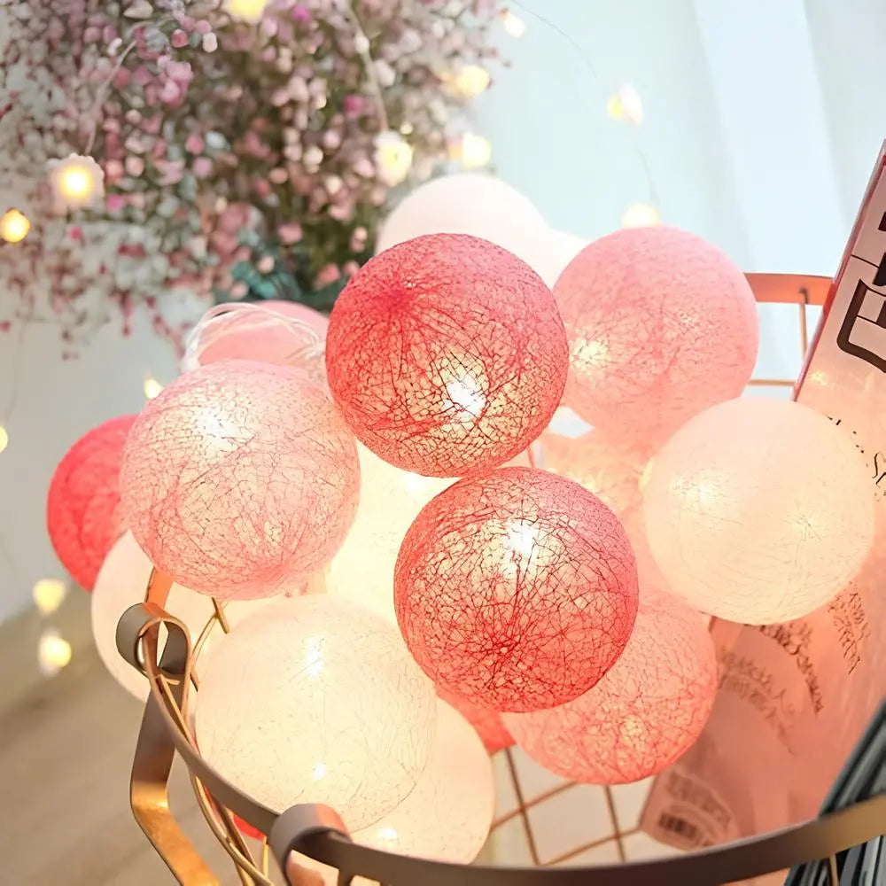 Warm LED cotton ball garland illuminating a festive dinner setup, enhancing party decor.