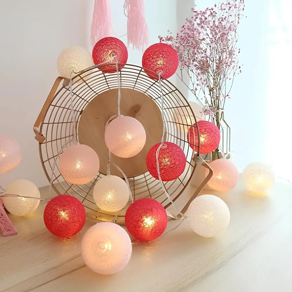 Aesthetic lighting: warm LED cotton ball string lights creating a soft glow in a dark room.