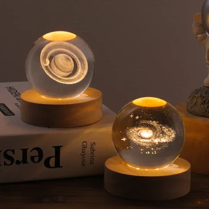 Mesmerizing 3D galaxy crystal ball, luminous and set on a wooden base. Functions as a night light or decor.