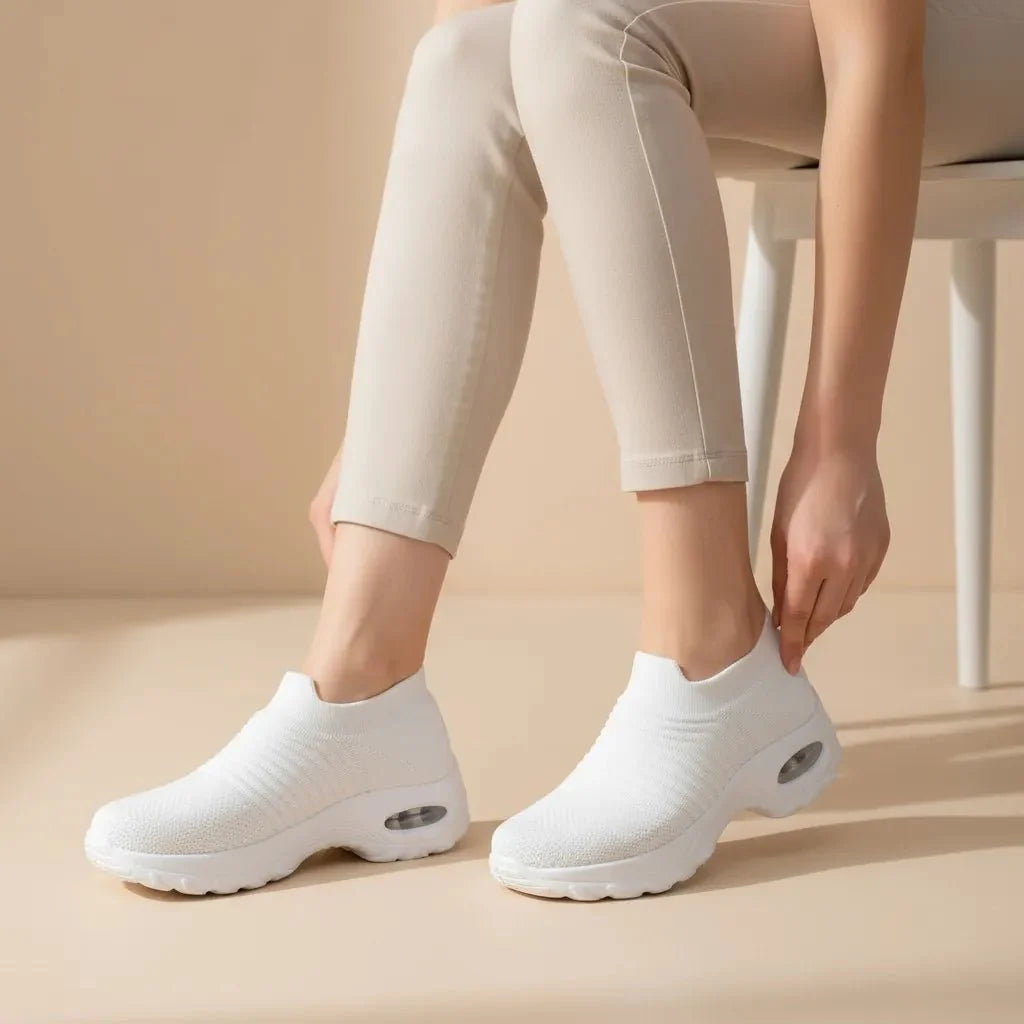 Versatile White women's sneakers: slip-on, arch support, air cushion sole for ultimate comfort.