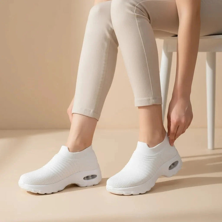Versatile White women's sneakers: slip-on, arch support, air cushion sole for ultimate comfort.