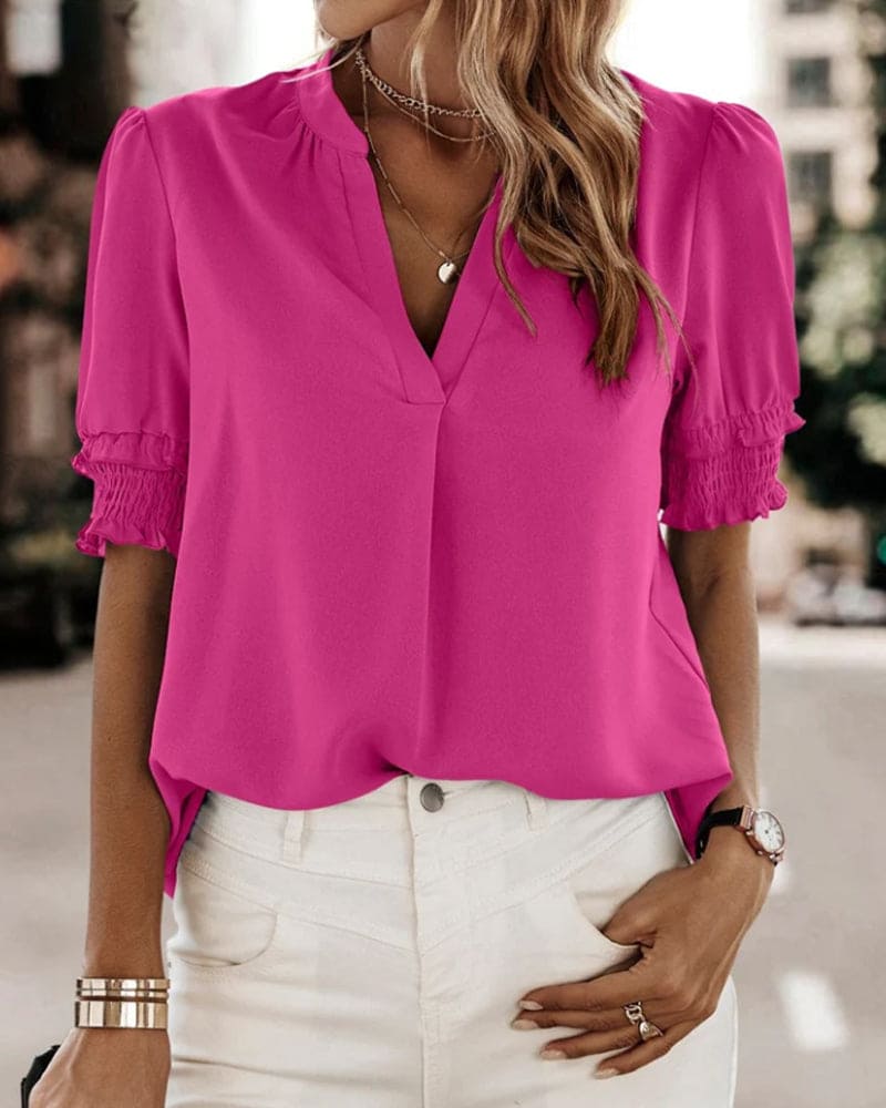 Women's V-neck puff sleeve blouse. Short sleeve top for chic, comfortable style.