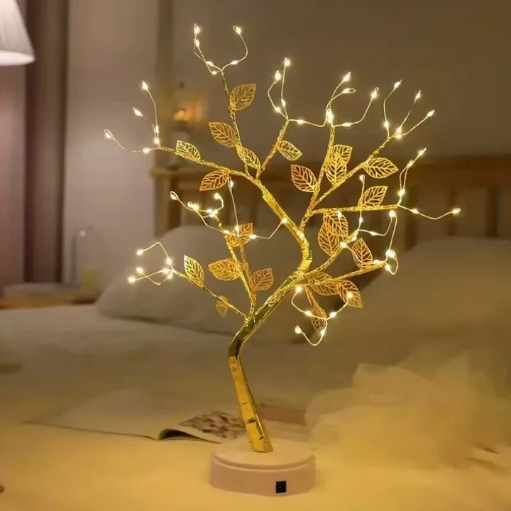 Close-up of golden leaf details on a Warm White LED Bonsai Tree Lamp. Decorative table accent.