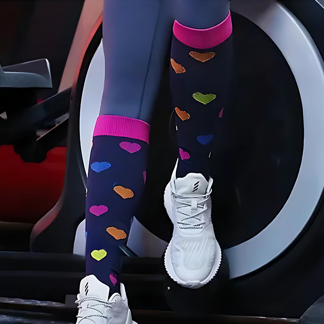 Close-up of heart pattern on women's compression socks for stylish leg support & circulation.