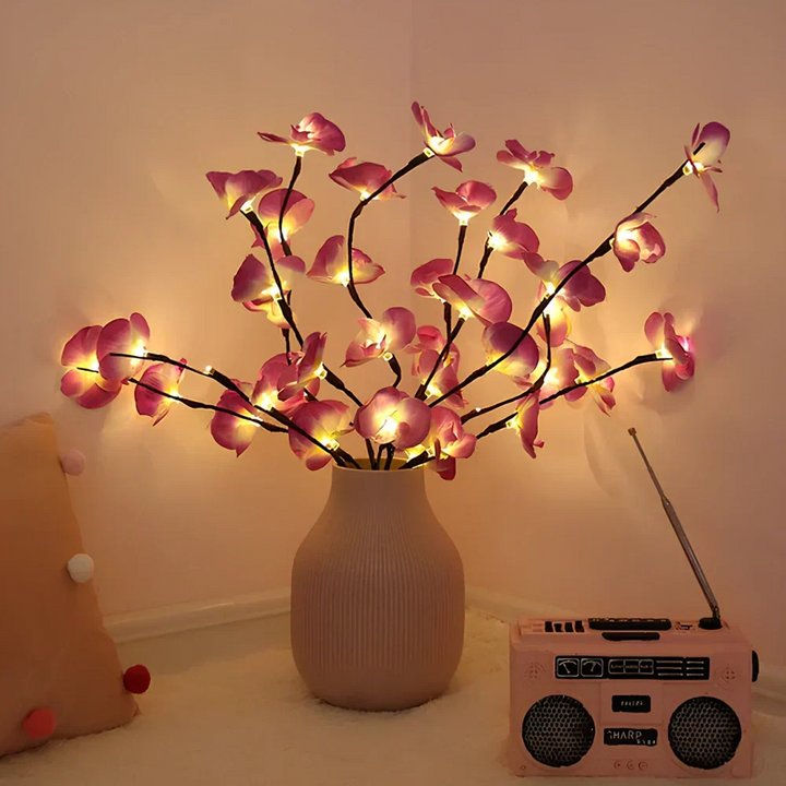Lighted twig branches with delicate LED flowers, enhancing home decor with soft glow.
