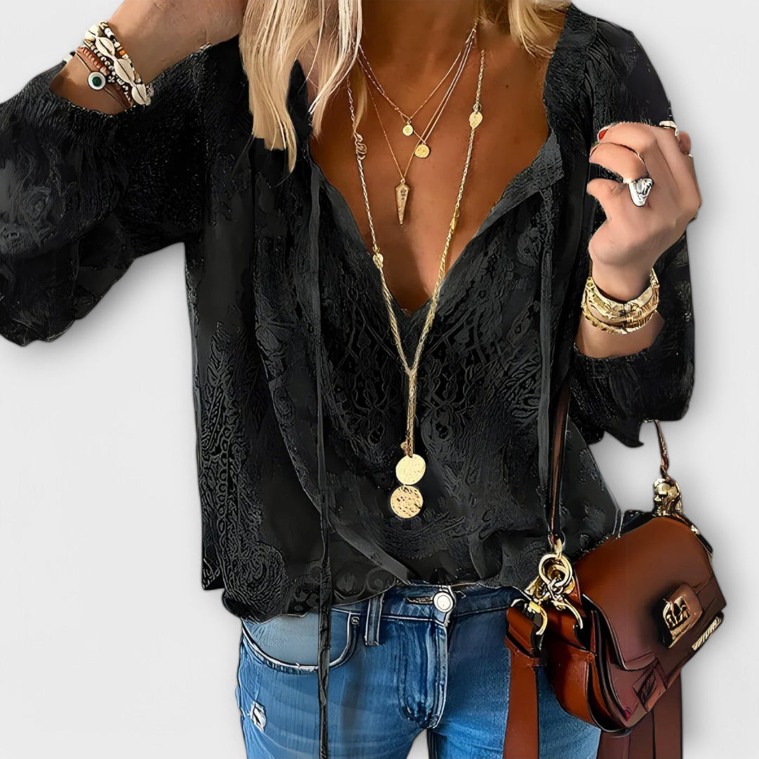 Boho chic women's long sleeve lace top, featuring a flattering V-neck and trendy tie front design.