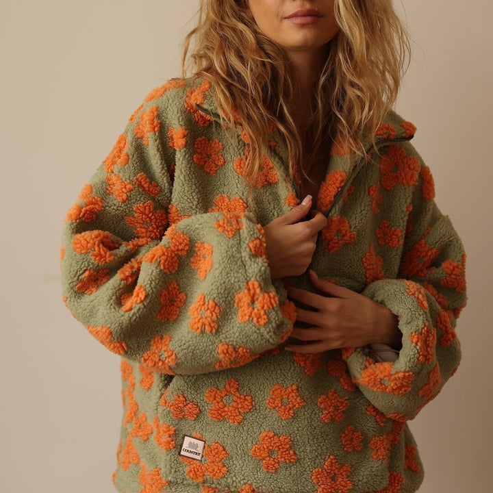 Plush women's floral teddy fleece oversized sweater. Warm half-zip for cozy winter style.