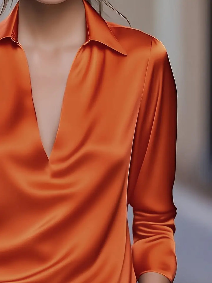 Sophisticated women's V-neck blouse, flowing fit, ideal for elegant office style.