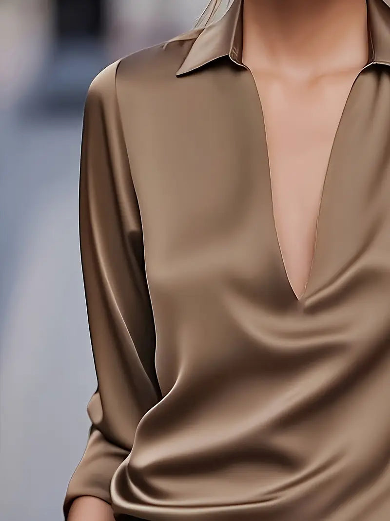 Elegant women's V-neck top, flowing fit for office wear and casual chic style.