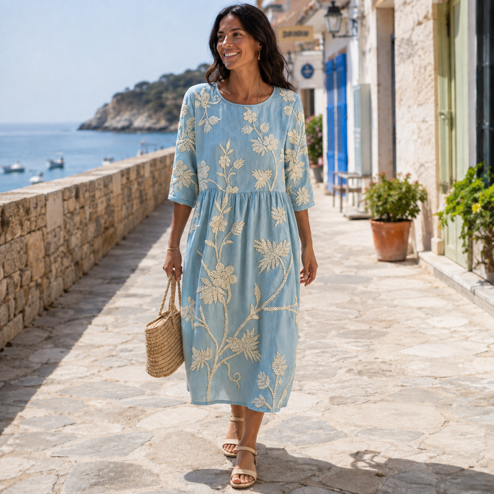 Relaxed fit women's floral midi dress with a round neck, comfortable for summer days.