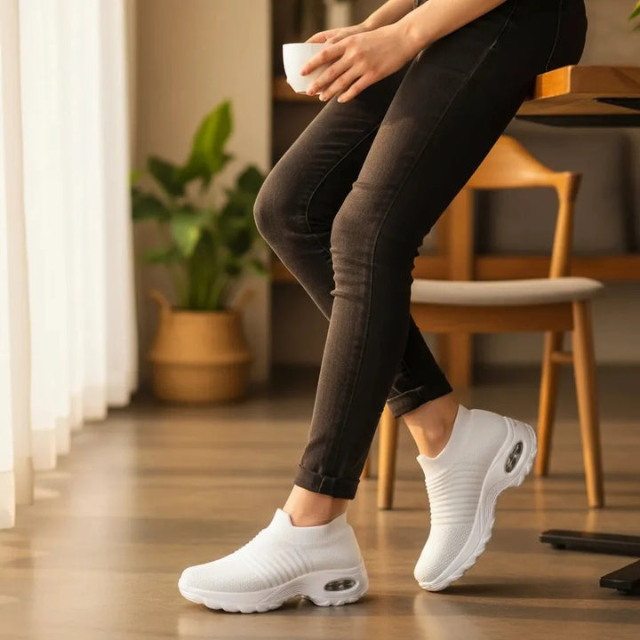 All-day comfort with White women's slip-on sneakers. Features arch support, perfect for casual walks.