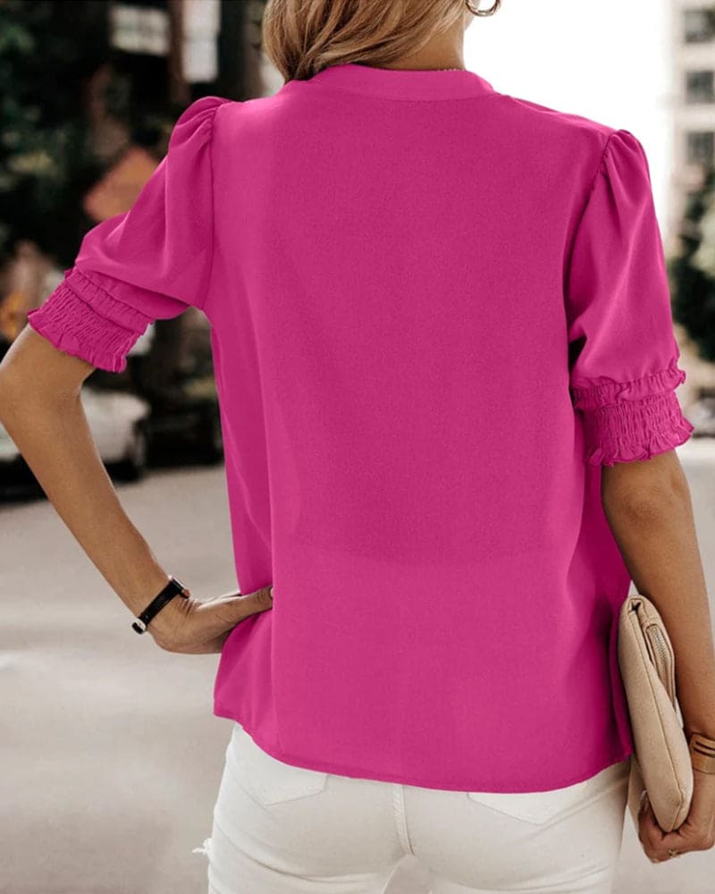Comfortable women's V-neck puff sleeve blouse. Relaxed fit short sleeve top for effortless style.