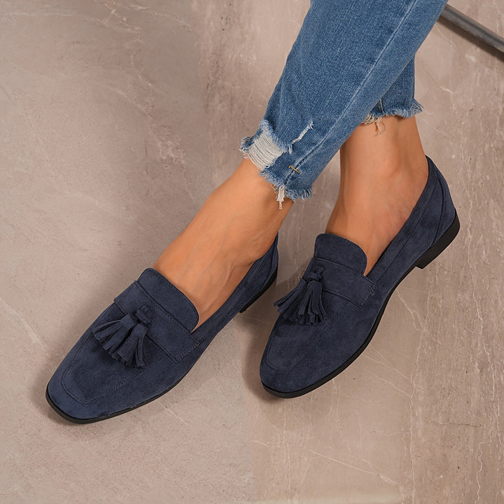 Women's navy blue fashion loafers: elegant tassel slip-ons for sophisticated everyday wear.