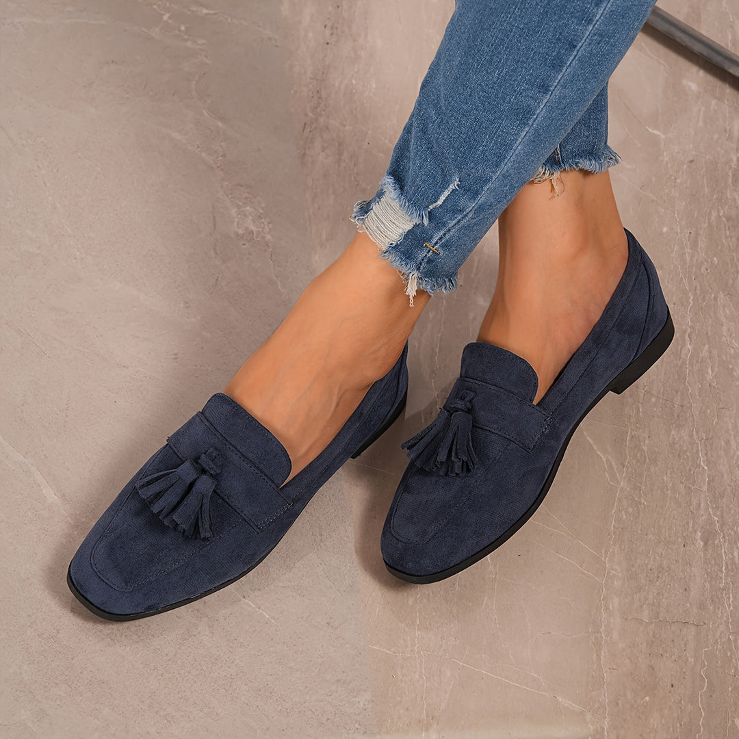 Elegant navy blue women's slip-on loafers featuring decorative tassels for chic office wear.